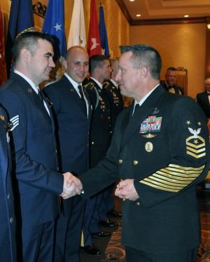 Fleet Master Chief Terrence I. Molidor, Command Senior Enlisted Leader for Headquarters, North American Aerospace Defense Command and United States Northern Command, Peterson Air Force Base, Colorado congratulates Sr. Airman James Comstock, New York Air National Guard Airman of the Year for his outstanding achievement during the Enlisted Association of the New York National Guard annual awards dinner, April 25 in Clifton Park, N.Y. Comstock is a supply technician assigned to the 109th Airlift Wing based in Scotia. Army National Guard Photo by Sgt. Major Corine Lombardo, Joint Force Headquarters/RELEASED.